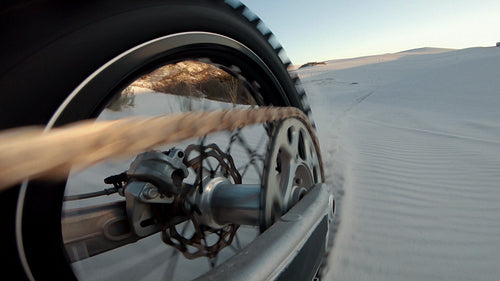 Dirt bike wheels turning on sand dunes