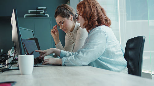 Computer programmers working on a code in a tech company