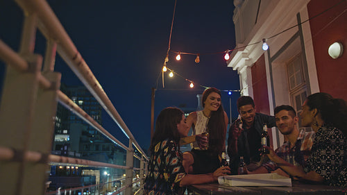 Travelers meet up at rooftop party