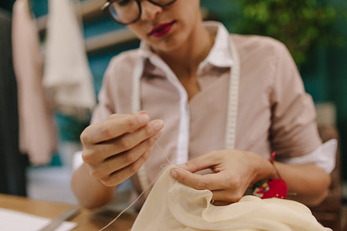 Woman hands doing handwork on dress