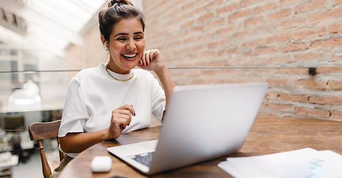 Happy small business owner having an online meeting in a warehouse
