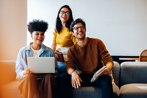 Business team working on laptop and phone in office