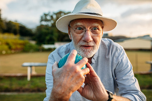 Close up of a man playing boules