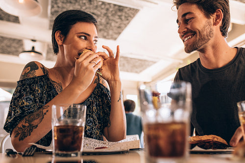 Couple at restaurant having burger