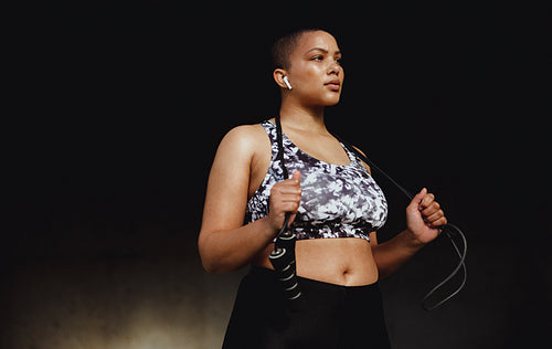 Healthy woman with a skipping rope on her neck