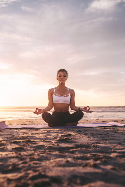 Woman meditating in lotus pose.