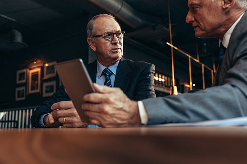 Senior business people meeting at modern restaurant.