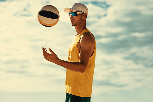 Beach volleyball: Setter throwing the ball mid-air in a summer sports tournament