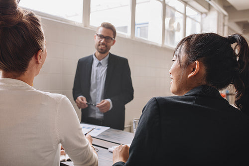 Female colleagues at business presentation in meeting room