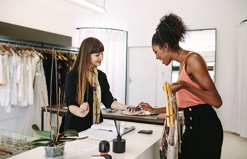 Woman entrepreneur making sale in her fashion studio