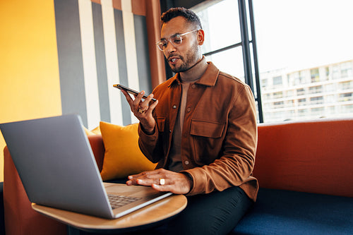 Young entrepreneur taking a phone call in an office lobby