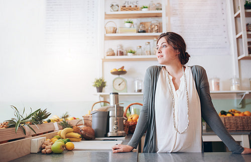 Attractive young woman standing behind the counter