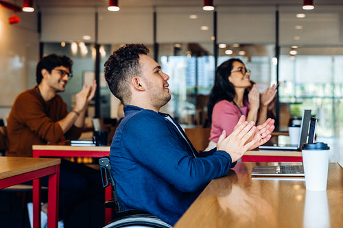 Business people applaud in office