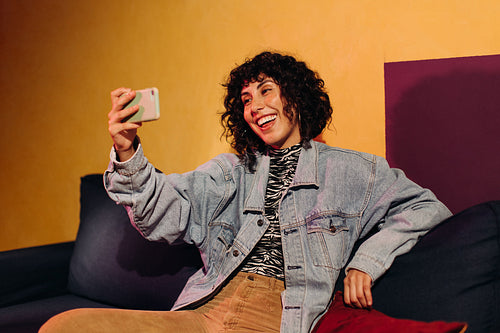 Carefree young woman having a video call on her smartphone