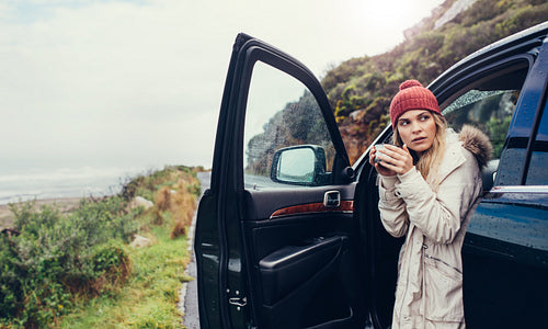 Female drinking coffee after road trip travel