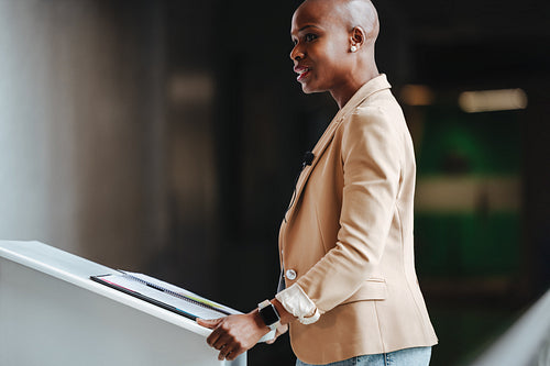 Elegant business woman giving a speech at a corporate seminar