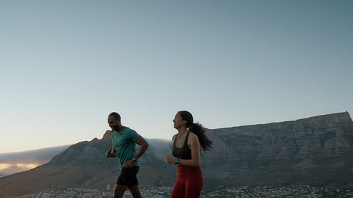 Couple running on a hillside road