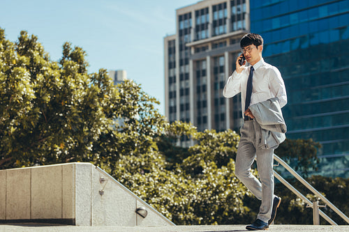 Businessman talking on his cell phone outdoors
