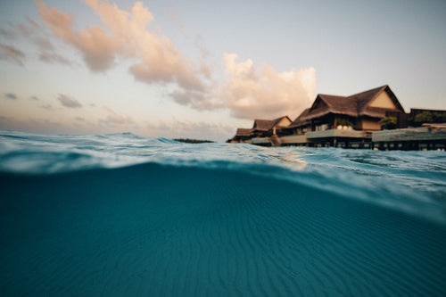 Seaside view of an ocean villa in the sunset