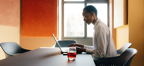 Professional person working independently at a desk in a bright office space