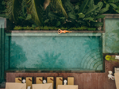 Female model lying at the poolside