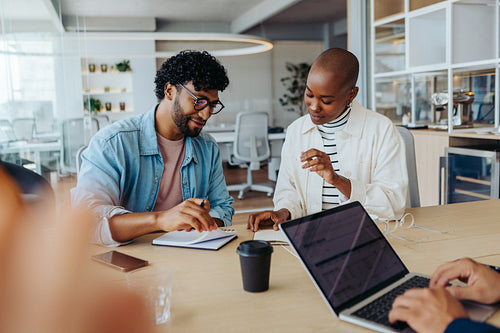 Two business people having a discussion in a collaborative meeting