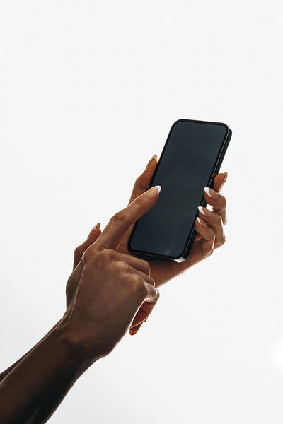 Hand operates a smartphone with focus on the touch gesture interaction