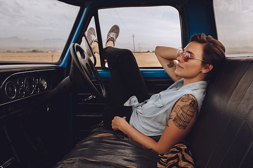 Woman taking break driving a truck on road trip