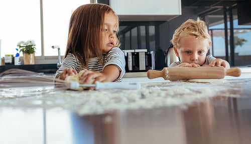 Kids preparing cookies in kitchen