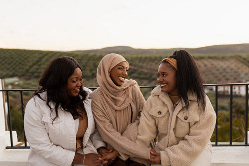 Friends holding hands outdoors