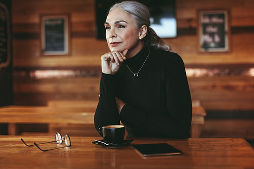 Thoughtful senior woman at coffee shop