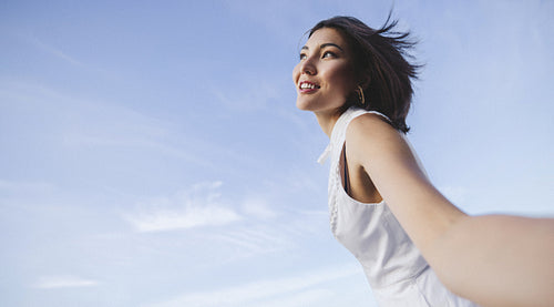 Woman taking a selfie outdoors in summer