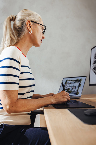 Professional architect designing on tablet in modern office workspace