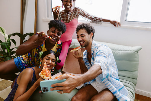 Friends gather for a selfie at a pizza party