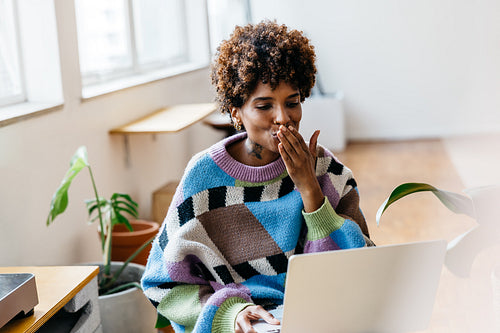 Freelance professional working and smiling in a co-working space
