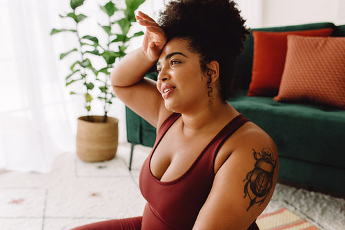 Body positive female tired after practicing yoga