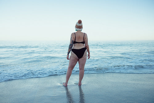 Middle aged woman watching the sea waves at the beach