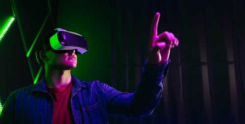 Gaming in virtual reality: Man playing with objects in the digital world