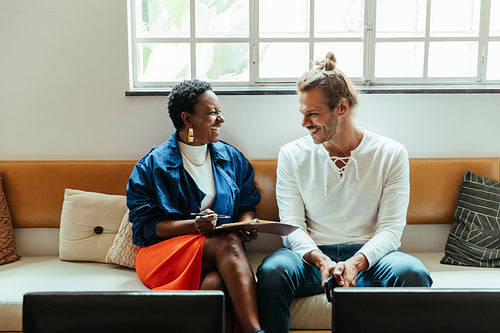 Happy colleagues sharing a light moment in a modern, stylish office environment