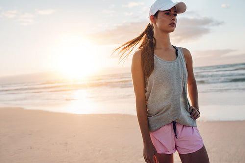 Fit young woman standing on the beach