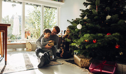 Family celebrating Christmas with gifts