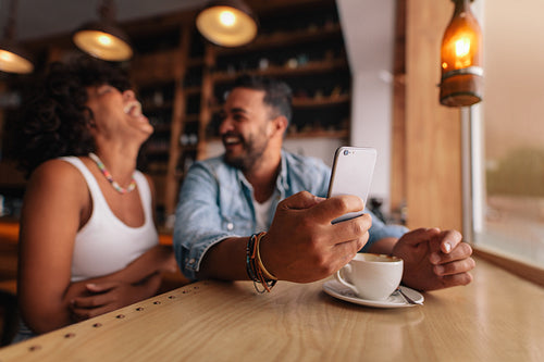 Young couple enjoying at coffee shop