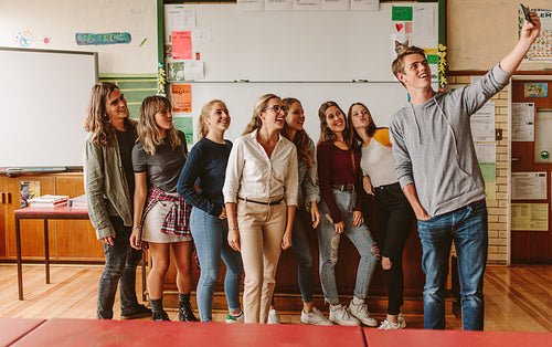 University students taking selfie with teacher