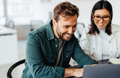 Successful business man using a laptop in a meeting with his colleague