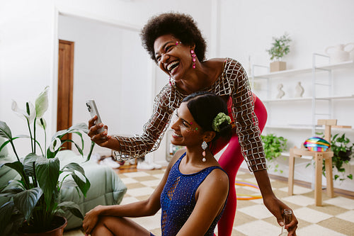 Carnival friends taking selfie indoors