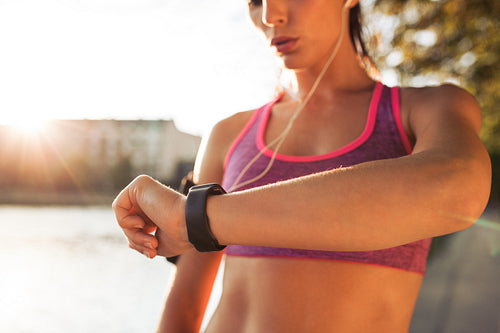 Sporty young woman checking pulse