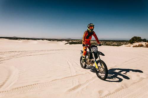 Moto racer riding in desert