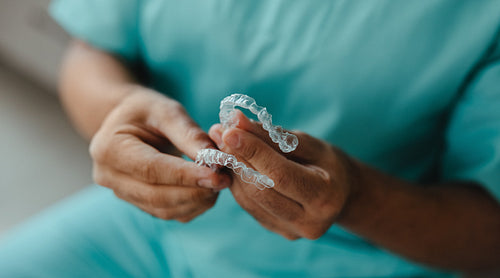 Dental aligner in hands for orthodontic treatment and clear teeth correction