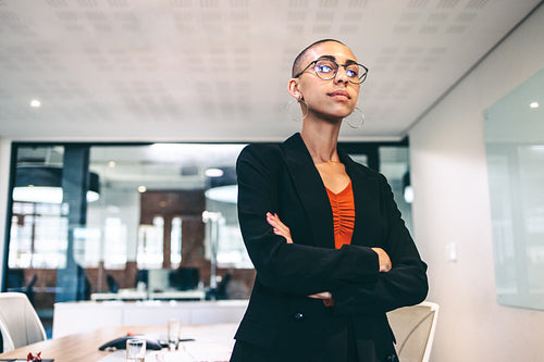 Self-assured businesswoman standing with her arms crossed