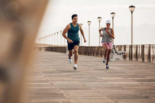Couple of runners competing on promenade